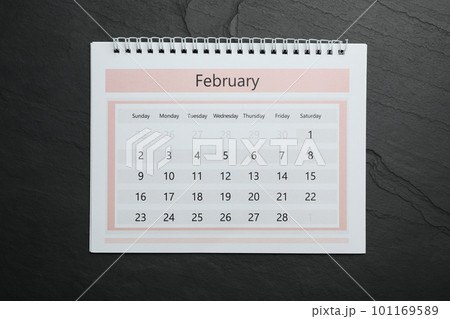 February calendar on black stone background, top view February calendar on black stone background, top view 101169589