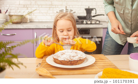 Portrait of little girl of three years old, kitchen, pie, dabbling, funny. decorates the cake. Portrait of little girl of three years old, kitchen, pie, dabbling, funny. decorates the cake. 101170391