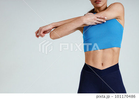 Close up of woman doing warm up hands exercises and stretching her body preparing to gym in studio 101170486