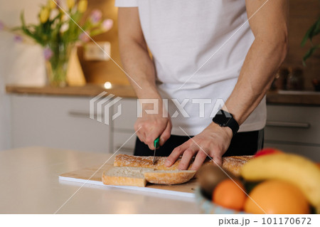Middle selection of man sliced baguette on wooden table in kitchen 101170672