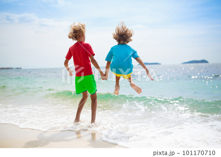 Kids on tropical beach. Children playing at sea. Kids on tropical beach. Children playing at sea. 101170710