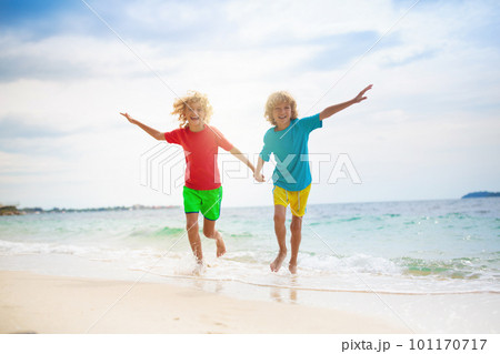 Kids on tropical beach. Children playing at sea. Kids on tropical beach. Children playing at sea. 101170717