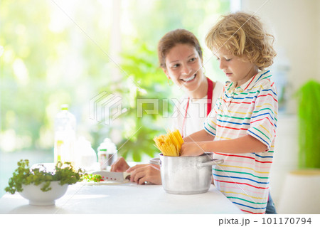 Family cooking dinner Mom and child cook spaghetti 101170794
