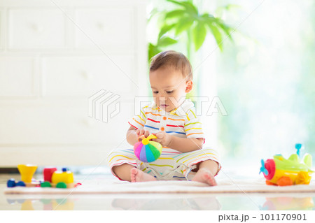 Baby boy playing with toy 101170901