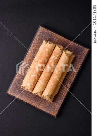 Delicious crispy wafer rolls with cream filling with nuts Delicious crispy wafer rolls with cream filling with nuts 101171309