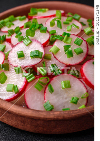 Delicious fresh salad of sliced ??radishes with green onions, salt and olive oil Delicious fresh salad of sliced ??radishes with green onions, salt and olive oil 101171348