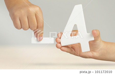 Minus four. The number four and the minus symbol in a hand close-up on a light gray background. The concept of removal or taking away 101172010