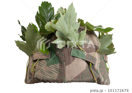 German Nazi Army steel helmet camouflaged with cover and tree leaves. World War II period 1933-1945. German Nazi Army steel helmet camouflaged with cover and tree leaves. World War II period 1933-1945. 101172678