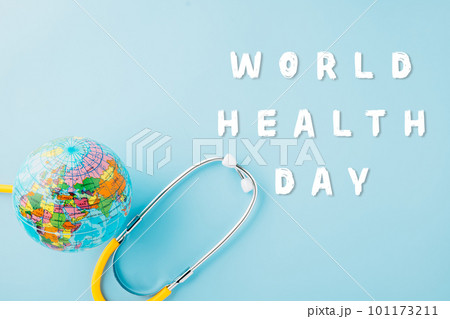 World Health Day. Top view yellow doctor stethoscope wrapped around world globe isolated on pastel blue background with copy space for text, Save world day, Health care and medical concept World Health Day. Top view yellow doctor stethoscope wrapped around world globe isolated on pastel blue background with copy space for text, Save world day, Health care and medical concept 101173211