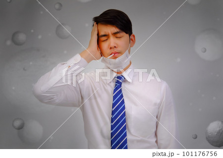 Asian man wear masks to protect PM 2.5 dust and air pollution and headache and sickness, air pollution concept, healthcare concept. 101176756