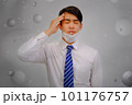 Asian man wear masks to protect PM 2.5 dust and air pollution and headache and sickness, air pollution concept, healthcare concept. 101176757