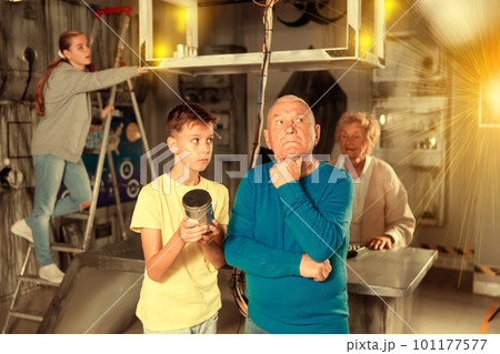 Grandchildren and grandparents in escape room Grandchildren and grandparents in escape room 101177577