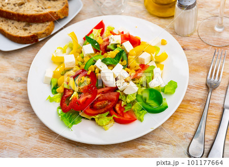 Salad with cheese, tomato, peppers, and corn Salad with cheese, tomato, peppers, and corn 101177664
