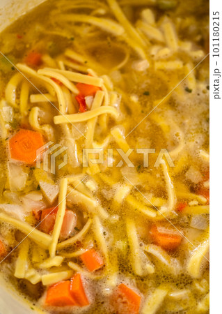 Cooking chicken noodle soup with kluski noodles in an enameled dutch oven. Cooking chicken noodle soup with kluski noodles in an enameled dutch oven. 101180215