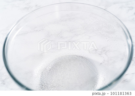 Rising dough in a glass mixing bowl to bake mini Easter bread kulich. Rising dough in a glass mixing bowl to bake mini Easter bread kulich. 101181363