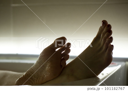 Feet in the bathroom closeup. Steamed female heels. Manicure. 101182767
