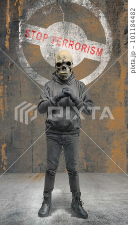 A man wearing a mask standing with a stop terrorism sign 101184482