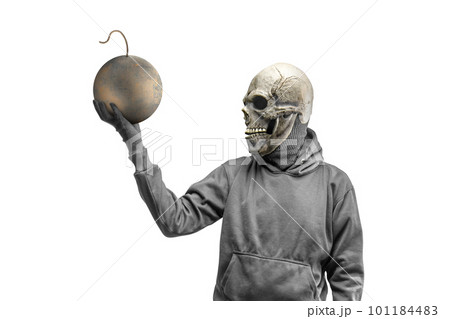 A man wearing a mask standing while holding a ball bomb 101184483