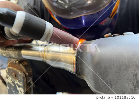 Worker welding metal stainless steel pipe by TIG welding. Worker welding metal stainless steel pipe by TIG welding. 101185516