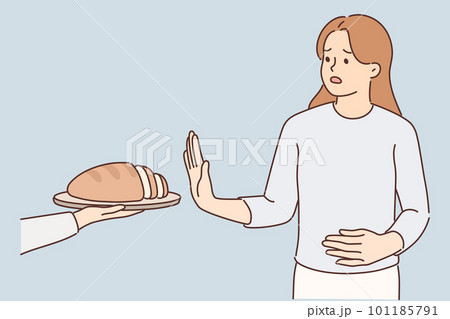 Frustrated woman holding on to stomach refuses bread due to allergies and gluten intolerance 101185791