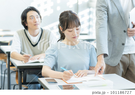 大学の教室で勉強する若い男女 大学の教室で勉強する若い男女 101186727