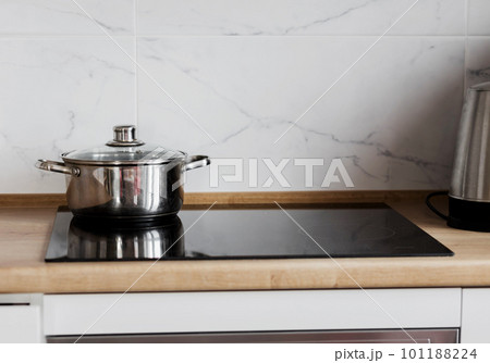 Black ceramic induction stove with metal pot 101188224