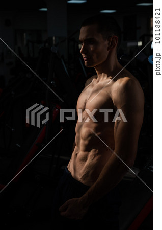 Shirtless man with sculpted body in the gym. Shirtless man with sculpted body in the gym. 101188421