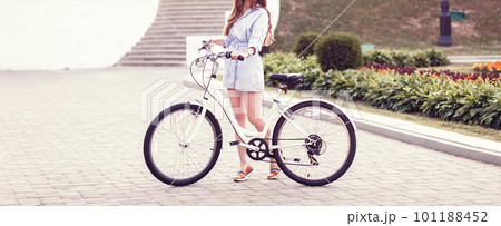 Pretty lady in dress with retro bicycle Pretty lady in dress with retro bicycle 101188452