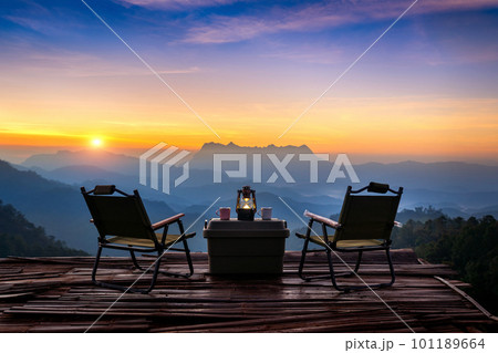 Outdoor camping table set at sunrise. Doi Luang Chiang Dao mountains in Chiang Mai. Outdoor camping table set at sunrise. Doi Luang Chiang Dao mountains in Chiang Mai. 101189664