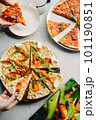 Traditional Italian pizza, vegetables, ingredients on a light background.Top view. a piece of pizza in the hand.Festive table. company of friends 101190851