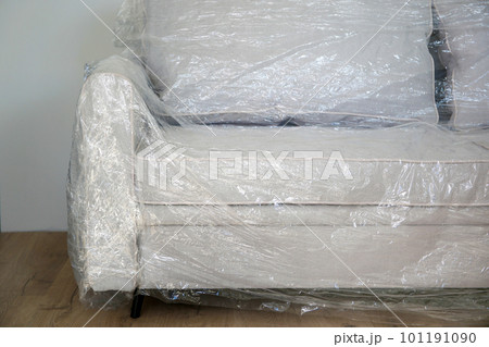 Packed sofa in the living room. The concept of moving. Packed sofa in the living room. The concept of moving. 101191090