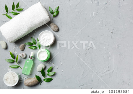 Coconut with jars of coconut oil and cosmetic cream on colored background. Top view. Free space for your text. Natural spa coconut cosmetics and organic treatment concept Coconut Spa composition Coconut with jars of coconut oil and cosmetic cream on colored background. Top view. Free space for your text. Natural spa coconut cosmetics and organic treatment concept Coconut Spa composition 101192684