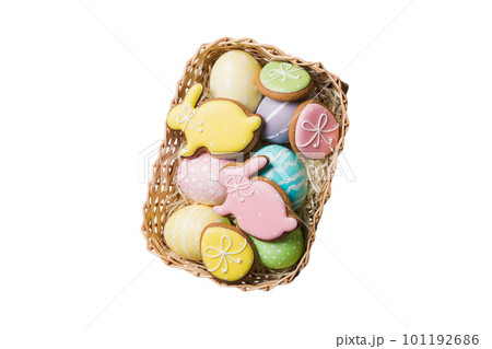 Colorful easter cookies in basket with Multi colors Easter eggs isolated on white background. Pastel color Easter eggs. holiday concept 101192686