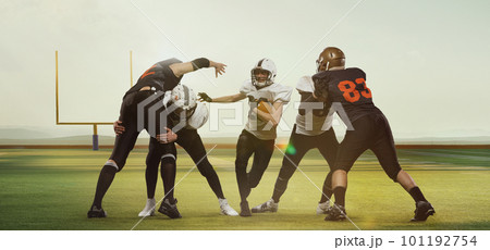 Professional american football players in uniform during game, training at open air 3D field with gate at daytime 101192754