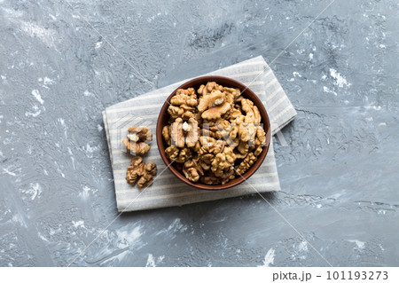 Fresh healthy walnuts in bowl on colored table background. Top view Healthy eating bertholletia concept. Super foods Fresh healthy walnuts in bowl on colored table background. Top view Healthy eating bertholletia concept. Super foods 101193273