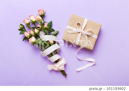 design concept with pink rose flower and gift box on colored table background top view. Happy Holiday, Mothers day, birthday concept. Romantic flat lay composition 101193602