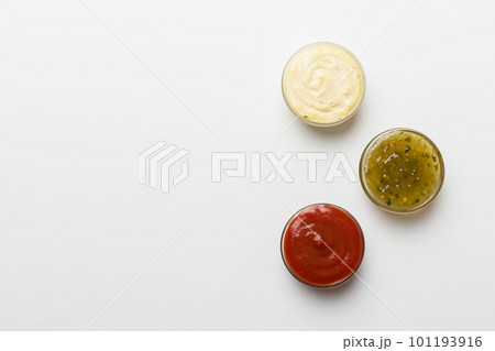 Different types of sauces in bowls on a colored Board . Top view. various sauces copy space 101193916