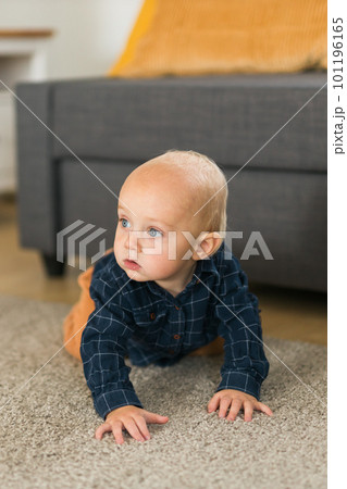 Nursery baby boy crawling on floor indoors at home copy space and empty space for text - Baby curiosity and child development stages Nursery baby boy crawling on floor indoors at home copy space and empty space for text - Baby curiosity and child development stages 101196165