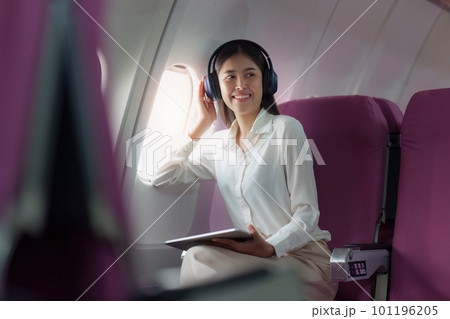 Beautiful Asian businesswoman working with digital tablet in aeroplane. working, travel, business concept 101196205
