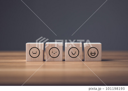 Sad face to smile face on wooden blocks cube arranged on wooden table. Idea of manythink to face and smile in finally. Sad face to smile face on wooden blocks cube arranged on wooden table. Idea of manythink to face and smile in finally. 101198193