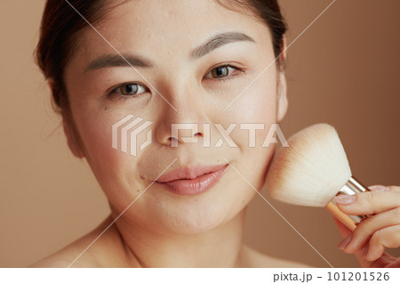 Portrait of modern asian woman with makeup brush Portrait of modern asian woman with makeup brush 101201526