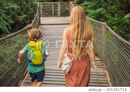 mother and son tourists in Rope bridge in Yildiz Park. Besiktas, Istanbul, Turkey. Turkiye. Traveling with kids concept mother and son tourists in Rope bridge in Yildiz Park. Besiktas, Istanbul, Turkey. Turkiye. Traveling with kids concept 101201719