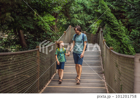 father and son tourists in Rope bridge in Yildiz Park. Besiktas, Istanbul, Turkey. Turkiye. Traveling with kids concept 101201758