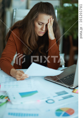 business owner woman in green office working with documents 101201781