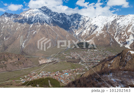 Aerial view of Stepantsminda townlet, Georgian mountain landscape 101202563