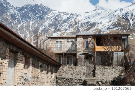 Stepantsminda street view with old stone houses, Georgia 101202569