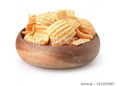 Wooden bowl of puffed ruffled chips 101202685