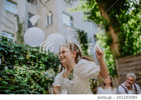 Little girl having fun at outdoor wedding party. 101203085