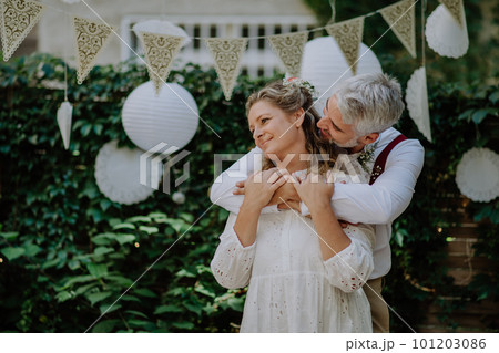 Close-up of bride and groom dancing at their outdoor wedding party. 101203086