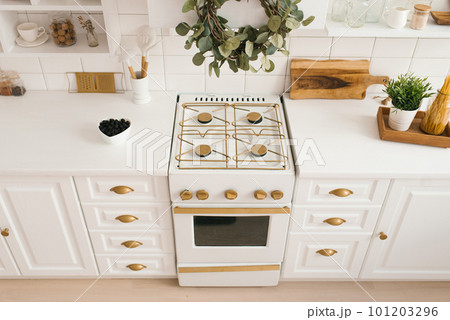 Modern new light wooden kitchen interior with white furniture and kitchen utensils Modern new light wooden kitchen interior with white furniture and kitchen utensils 101203296